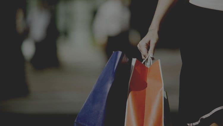 ladies hand holding shopping bags